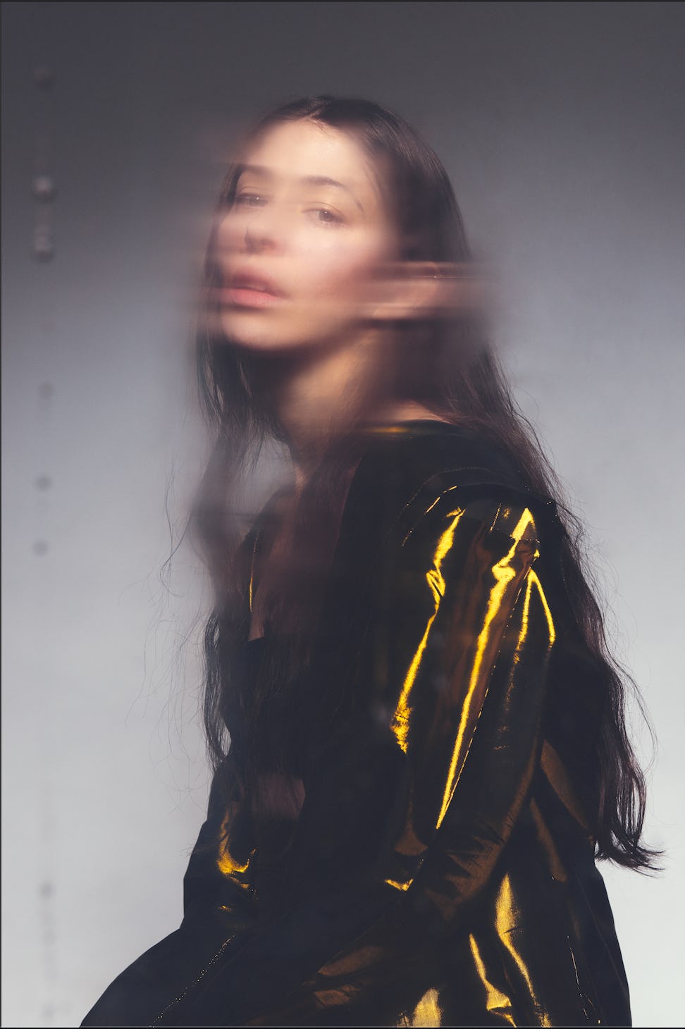 A blurry girl with a golden jacket