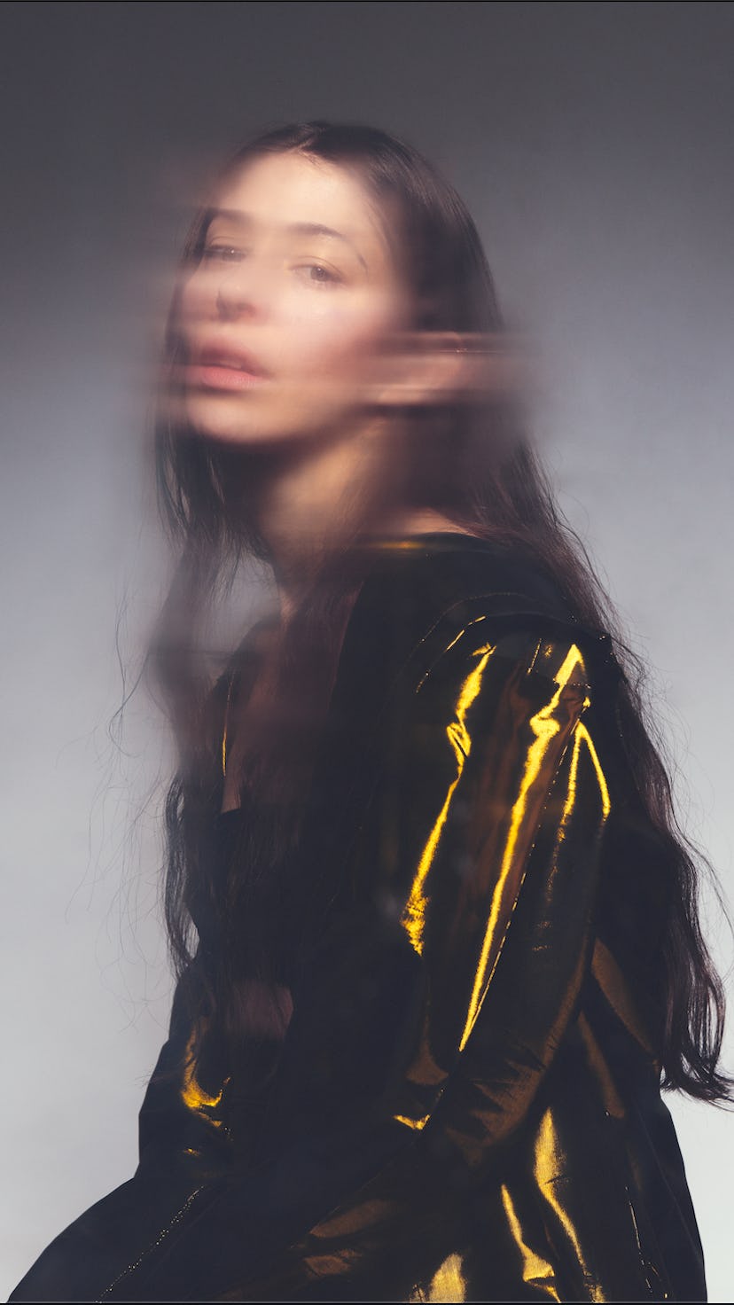 A blurry girl with a golden jacket