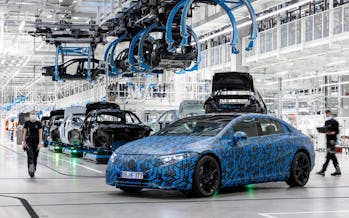 Prototype of the Mercedes-Benz EQS electric sedan parked in a manufacturing plant. 