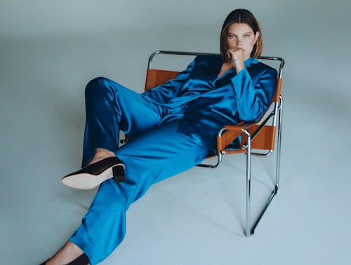 Plus-size model posing in a blue silk combination of a blazer and pants