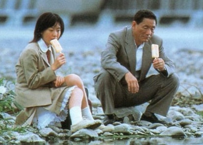 Two members of the Battle Royale cast eating vanilla ice cream while sitting on rocks