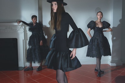 Three models posing in different design of black dresses by Matchesfashion