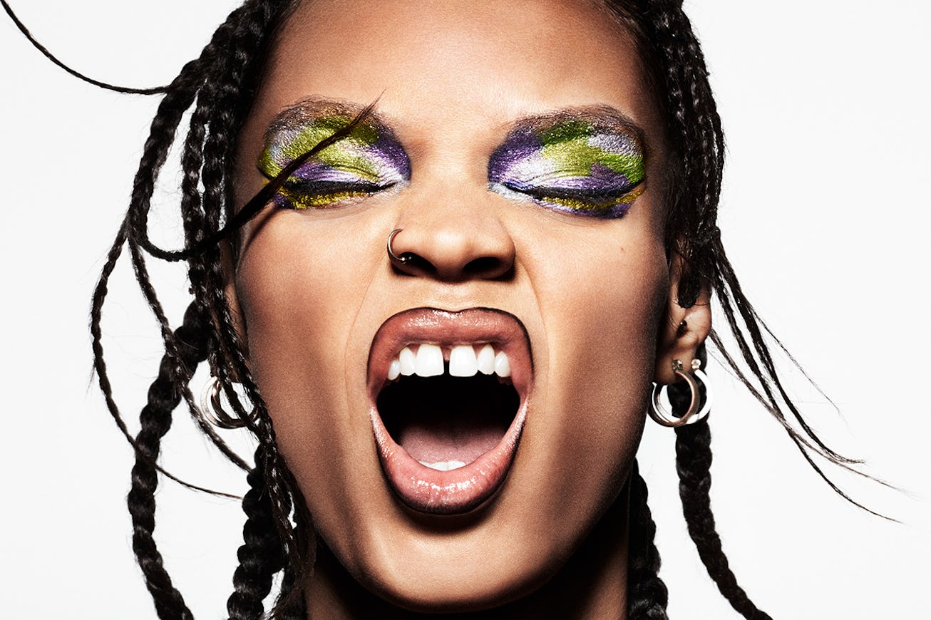 A model, with eyes closed, showcases a colorful makeup look created using MAC Cosmetics's Biobrillia...