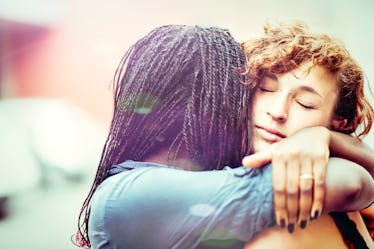 African woman supporting her Caucasian girlfriend