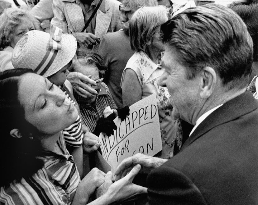 A supporter of Republican presidential hopeful Ronald Reagan puckers up in hopes of getting a kiss f...