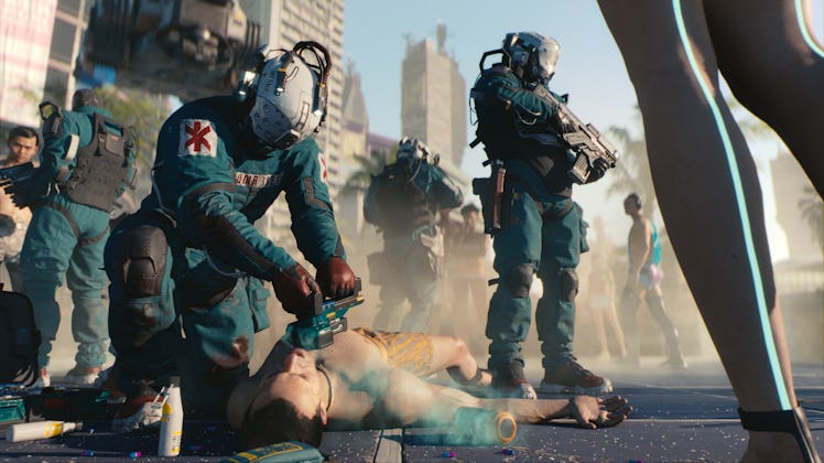 A medic trying to revive a person on the street in cyberpunk 2077