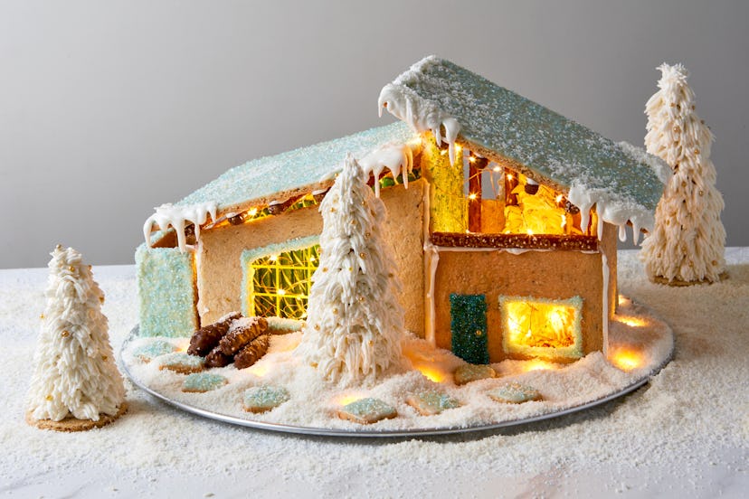 midcentury modern style gingerbread house with a glittery teal roof and light up inner.