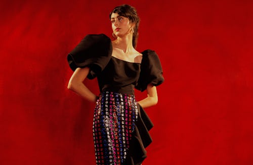 A model wearing a black top with puffer sleeves and a skirt by Markarian