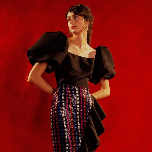 A model wearing a black top with puffer sleeves and a skirt by Markarian