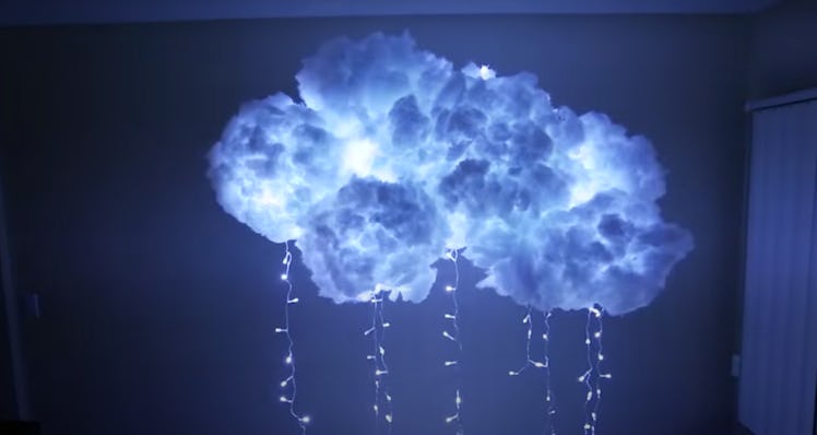 A homemade DIY cloud wall light hangs in a bedroom.