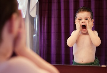 Child pretending to scream in mirror