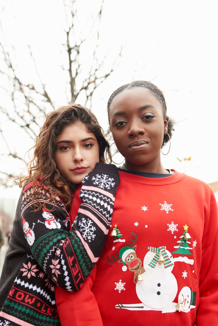 Friends posing in Christmas sweaters