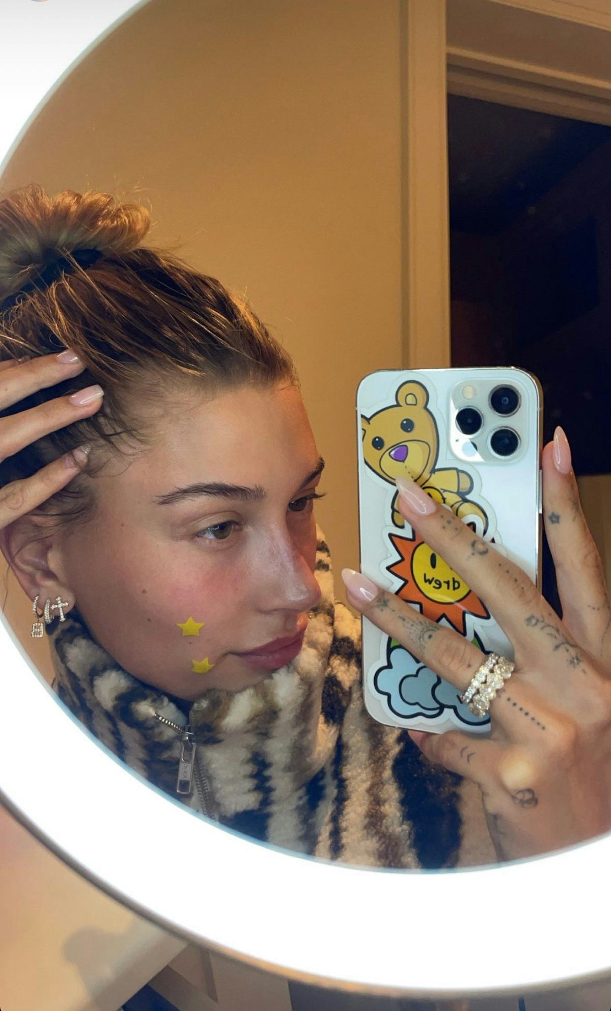 Hailey Bieber wearing Starface's Hydro-Stars in a selfie.