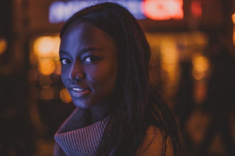 Girl illuminated by city lights