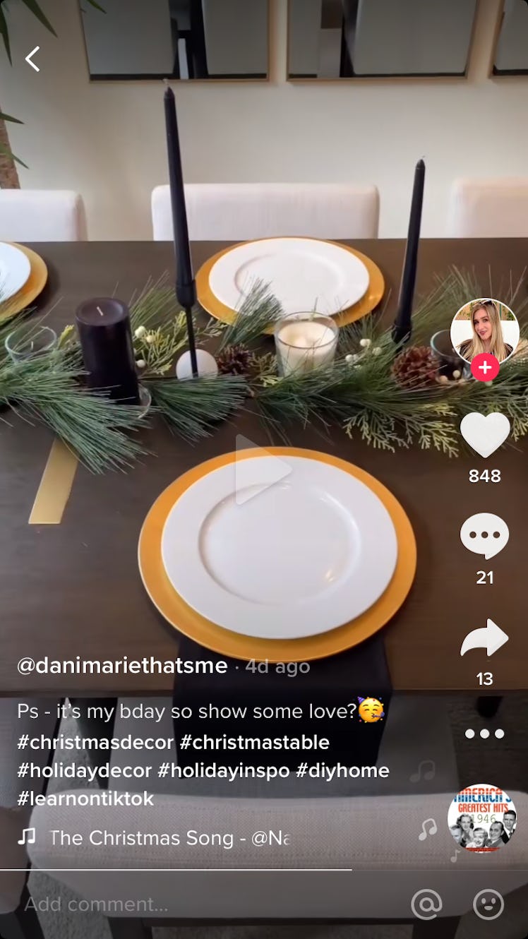 A woman shows how she decorates a modern Christmas table on TikTok, by adding black and white candle...