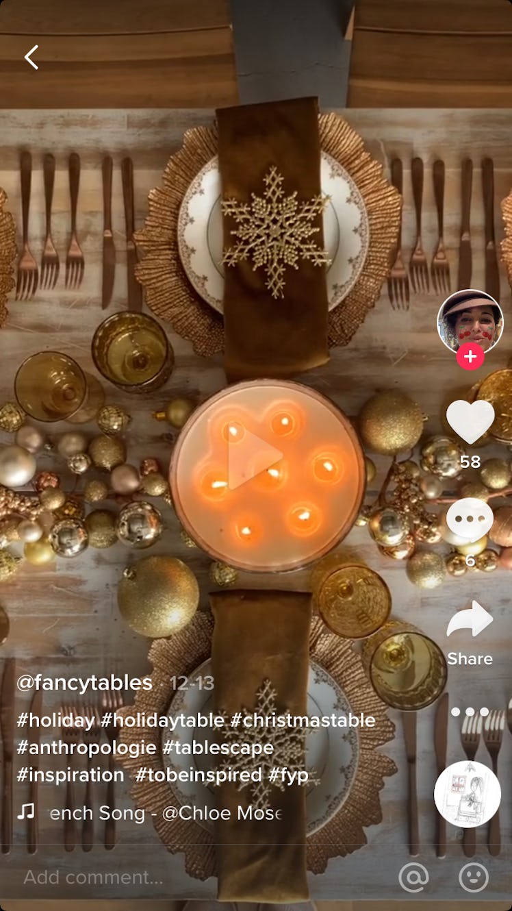 A TikTok user decorates a Christmas dinner table with gold charger plates, snowflake napkin rings, a...