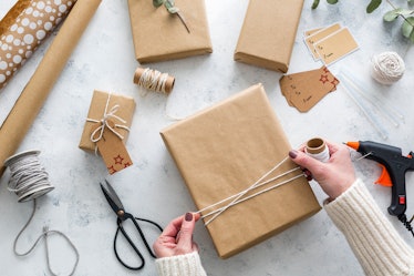 Person wrapping presents in plain brown paper