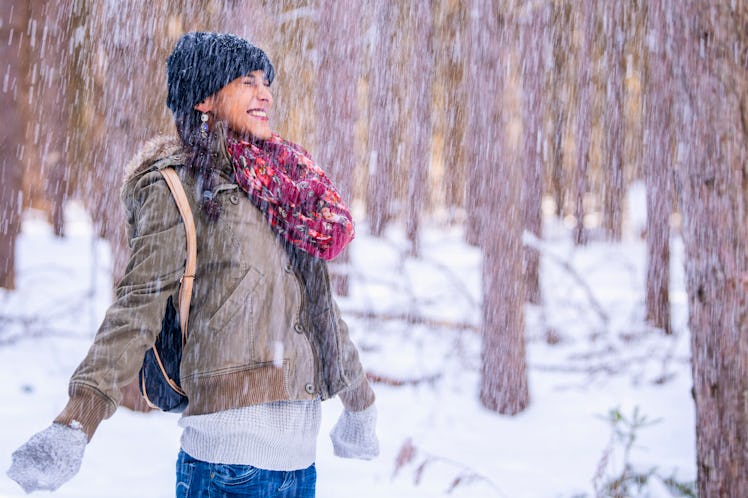 Snowing on woman in winter