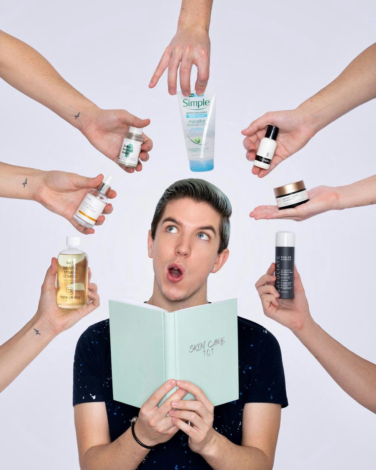 Hyram poses with hands holding skincare products