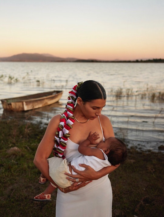 The artist Cynthia Cervantes breastfeeds her baby in front of a beautiful ocean bay.