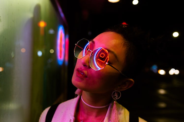 Portrait of young woman under neon light