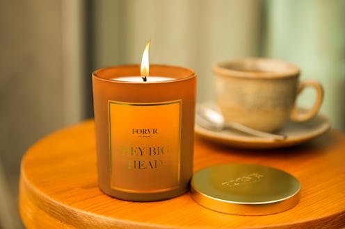 Forvr Mood's 'Hey big head' scented candle with cup of coffee in the background