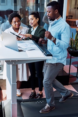 Coworkers meet at a treadmill desk