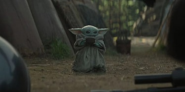 Baby Yoda drinks soup from a bowl in 'The Mandalorian'.