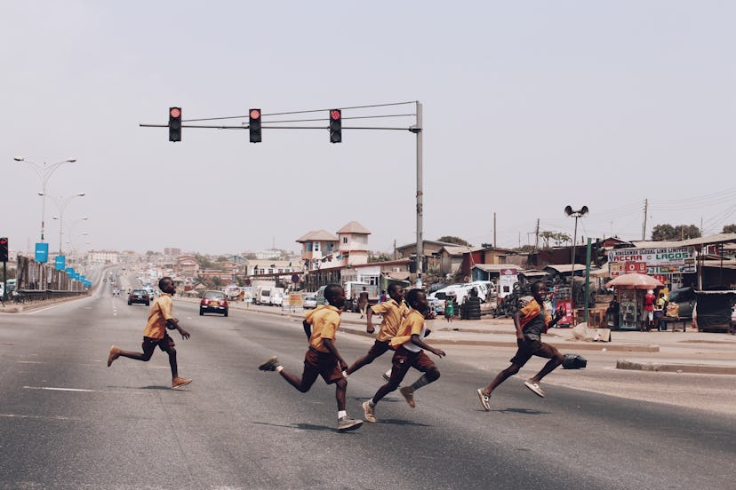 A group of school boys cross the highway. Accra, Ghana.