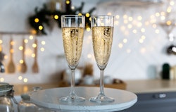 Two champagne flutes on a tray in a story about New years eve captions 2023