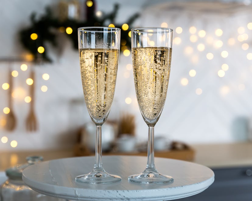 Two champagne flutes on a tray in a story about New years eve captions 2023
