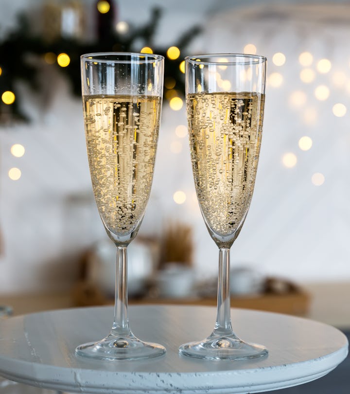 Two champagne flutes on a tray in a story about New years eve captions 2023