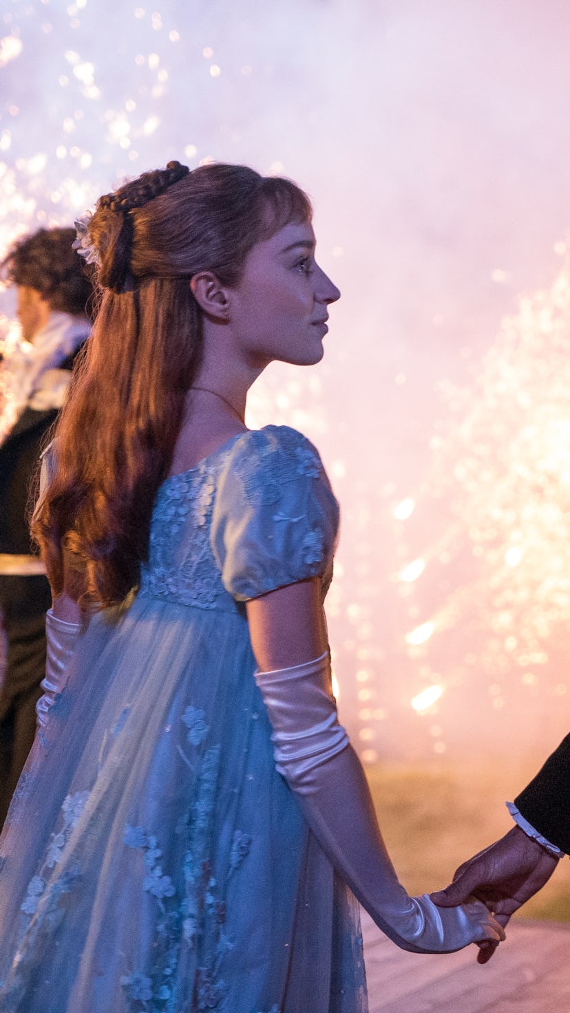 A still from Netflix Bridgerton featuring Daphne and Simon holding hands