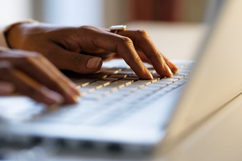 A woman from UK-Based support & advice for coping with an eating disorder typing on her laptop