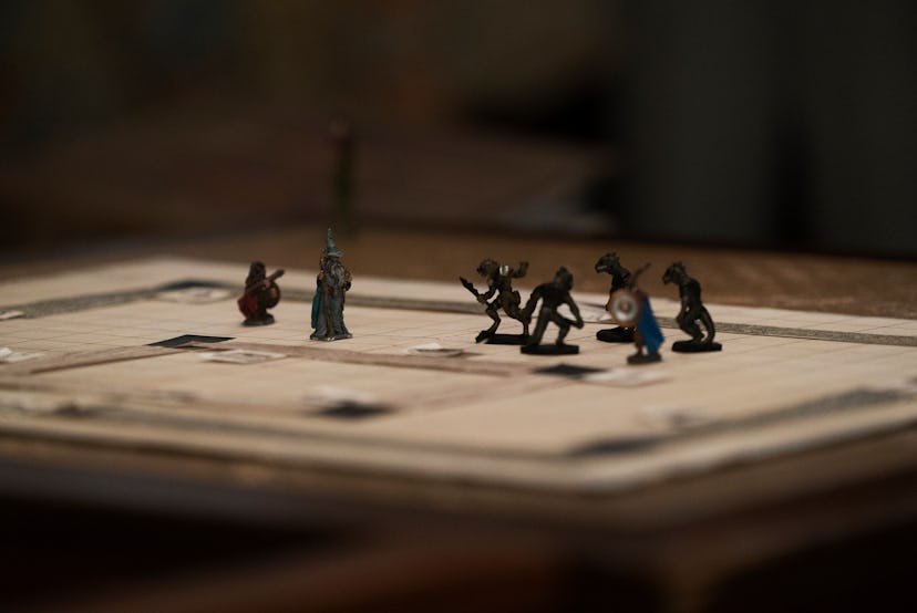 A production still of Stranger Things showing a dungeons & dragons game board with playing pieces. H...