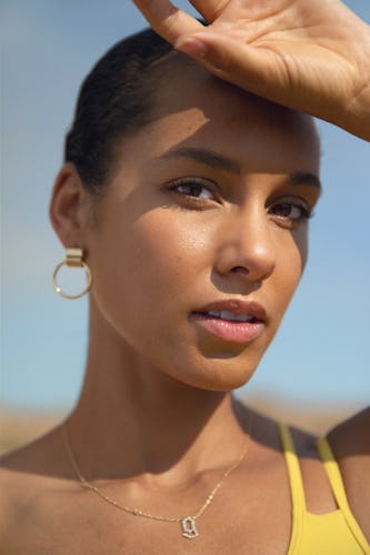 A close-up portrait of Alicia Keys, who is finally choosing Self-Care, with her hand on her forehead...