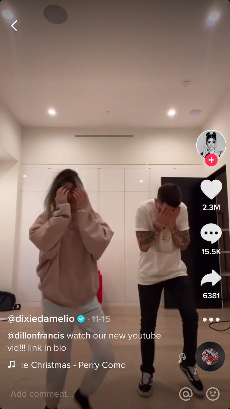 Dixie D'Amelio and a partner do the #ItsBeginningToLookLikeChrsitmas challenge on TikTok by hiding t...