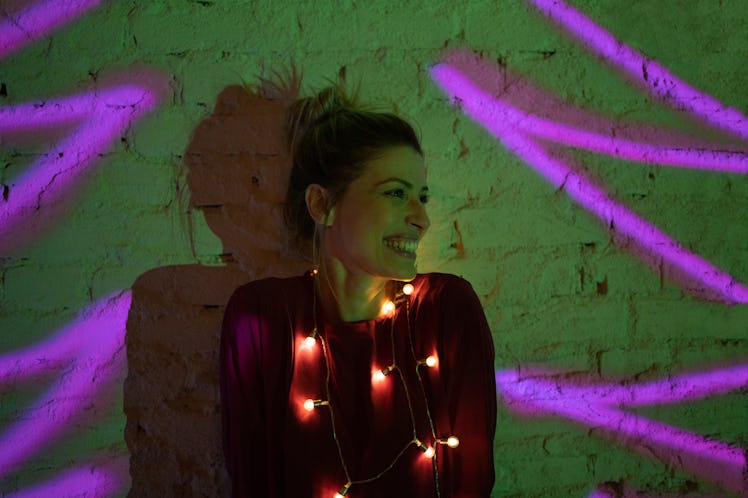 Young woman wearing Christmas lights