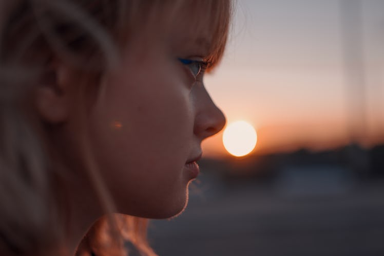 Portrait of a woman near the road at sunset