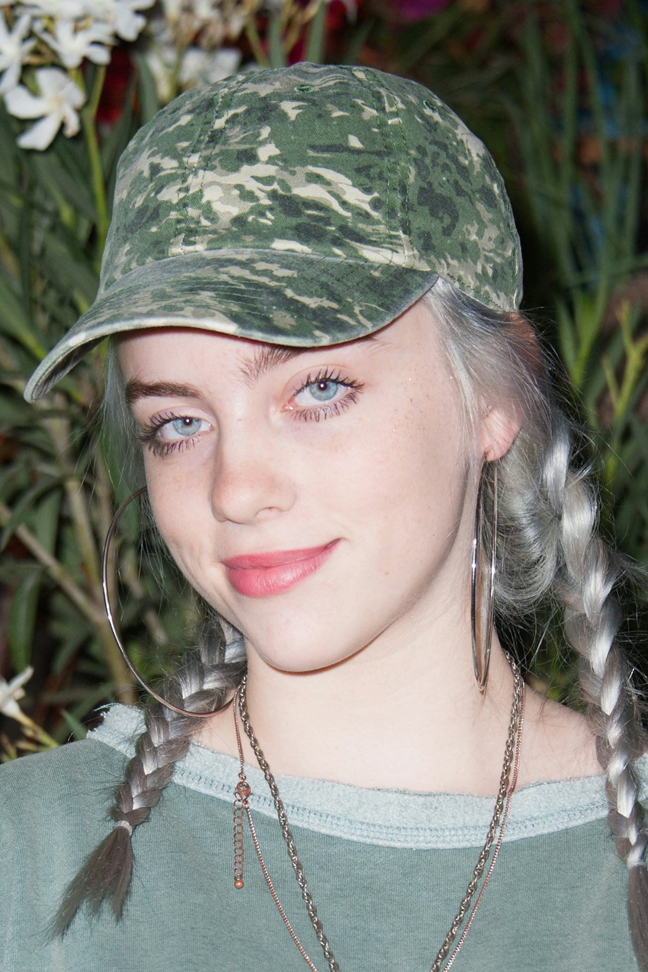 Billie Eilish wears a camouflaged cap