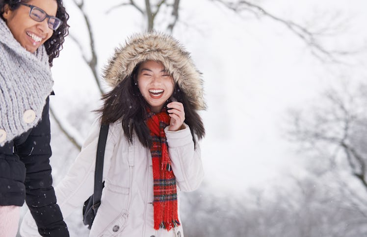 Two young woman walking in winter snow