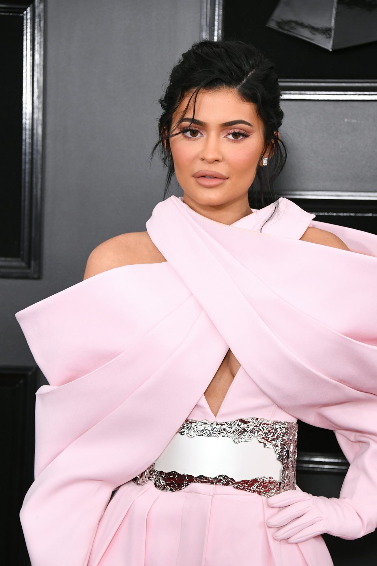 Kylie Jenner poses in a light pink outfit