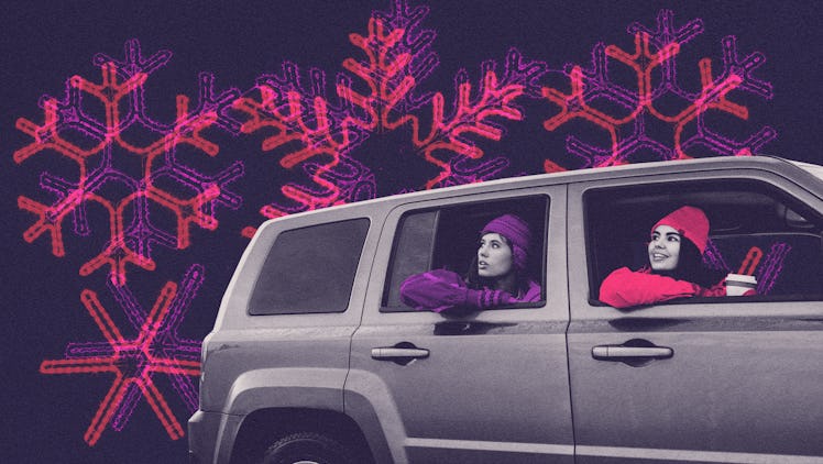 Two young women sit in a car and enjoy a drive-thru Christmas lights experience, in a purple and pin...