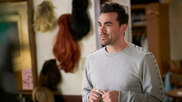 David Rose (Dan Levy) smiles while talking to this family in 'Schitt's Creek.'