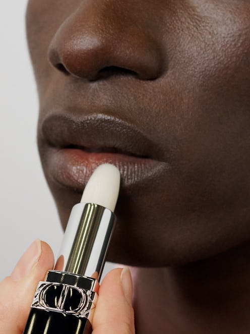 A model applying the Dior lip balm