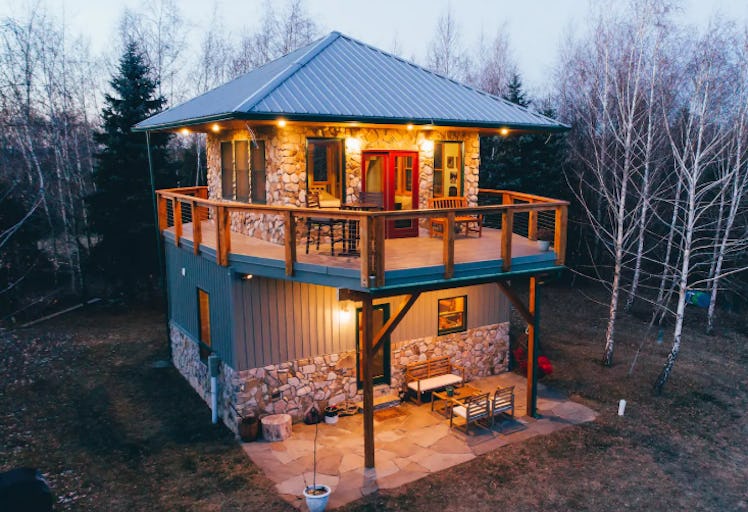 A fire tower retreat in the woods that is listed on Airbnb has a balcony on the second floor. 