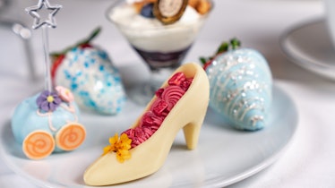 A plate is filled with 'Cinderella'-inspired desserts, including a white chocolate glass slipper and...