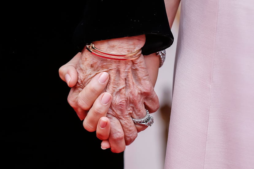 Laura Dern (R) and her mother Diane Ladd hold hands as they arrive for the 92nd annual Academy Award...
