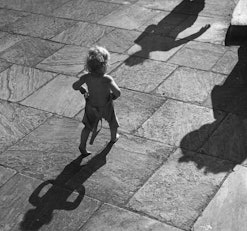 1980s toddler walks toward sun