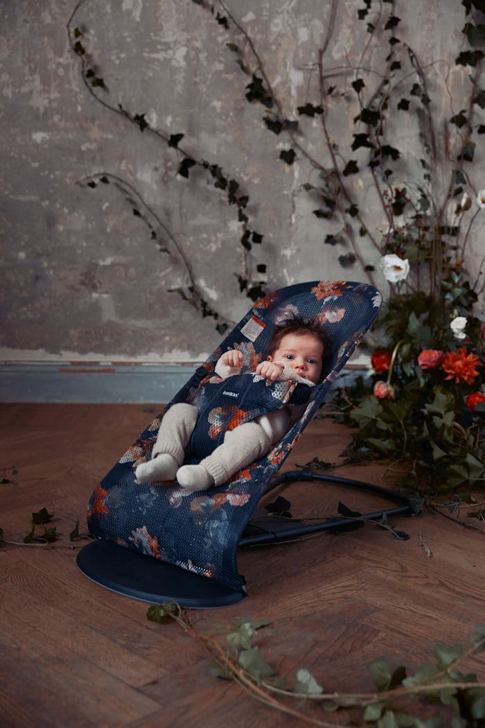 BabyBjörn's new midnight florals collection features two baby carries and a bouncer in a flower patt...